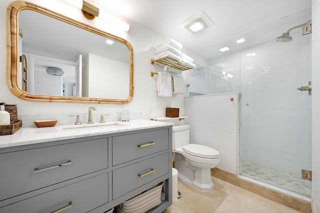 full bathroom with a shower stall, vanity, and toilet