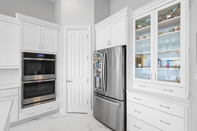 kitchen featuring appliances with stainless steel finishes and white cabinets