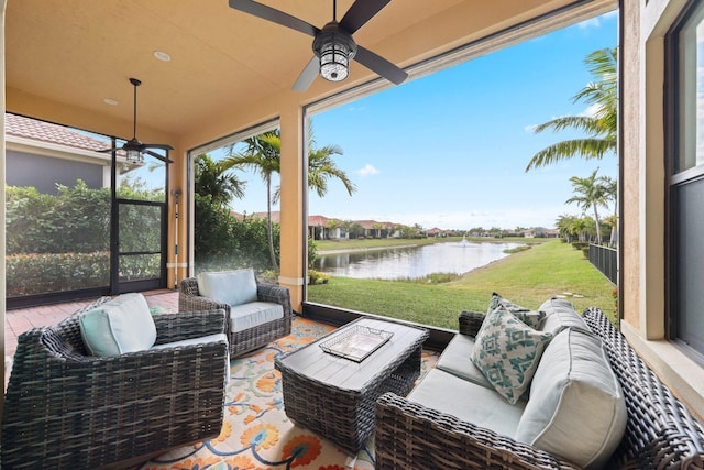 view of patio / terrace with a water view, ceiling fan, and outdoor lounge area