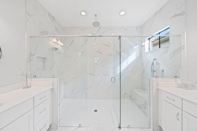 bathroom with a shower with door and vanity