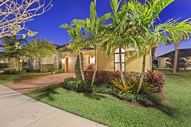 view of front of property featuring a garage and a front yard