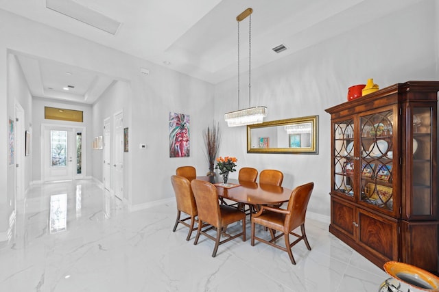 dining space featuring a tray ceiling