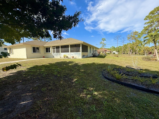 view of front of property with a sunroom and a front yard