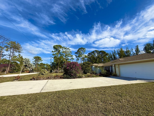 ranch-style home with a garage and a front lawn