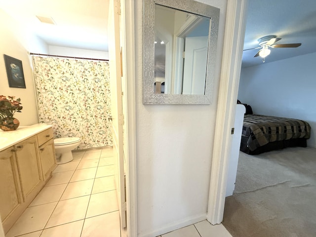 bathroom featuring vanity, tile patterned floors, ceiling fan, and toilet