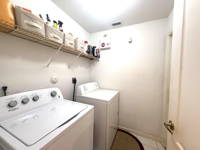 washroom with tile patterned flooring and separate washer and dryer