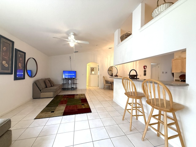 living room with ceiling fan and light tile patterned flooring