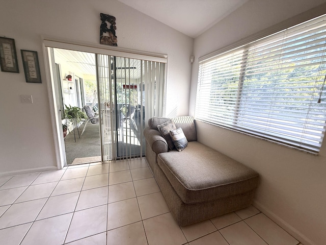 sitting room featuring lofted ceiling and light tile patterned floors