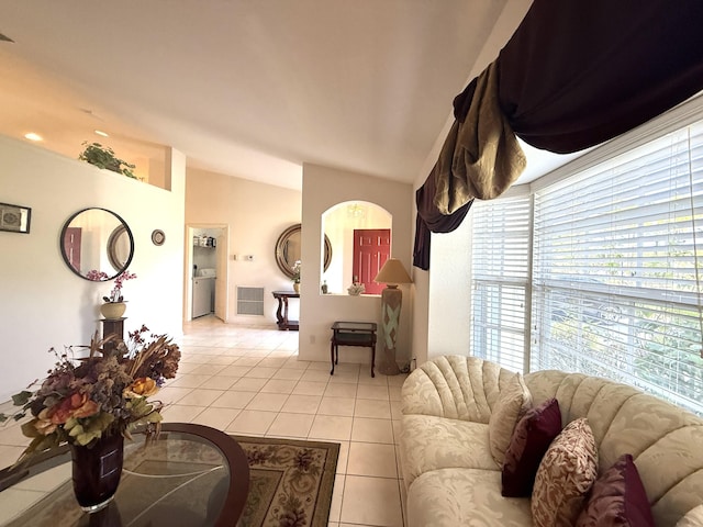 living room featuring light tile patterned flooring and vaulted ceiling