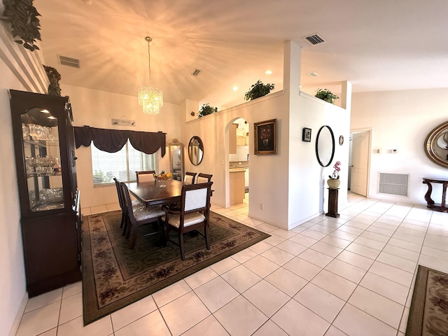 dining room featuring vaulted ceiling, light tile patterned floors, and a notable chandelier