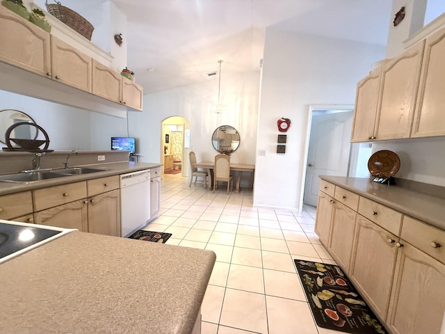 kitchen featuring light brown cabinetry, hanging light fixtures, sink, and dishwasher