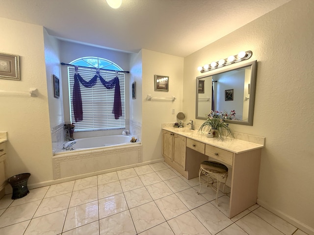 bathroom with vanity and tiled tub