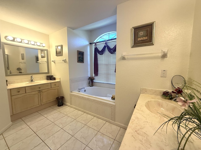 bathroom with vanity and tiled tub