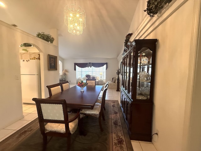 dining room with light tile patterned floors and a chandelier