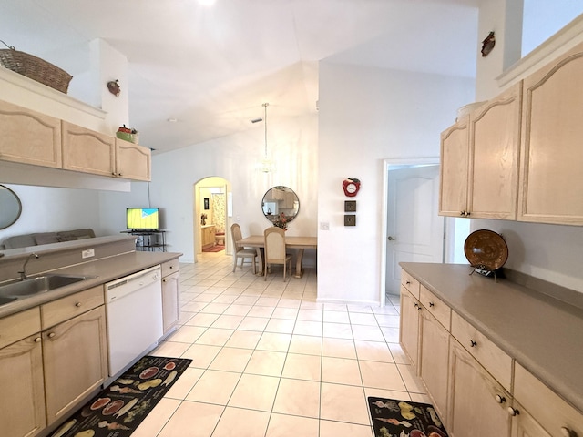 kitchen with sink, light tile patterned floors, dishwasher, light brown cabinetry, and decorative light fixtures