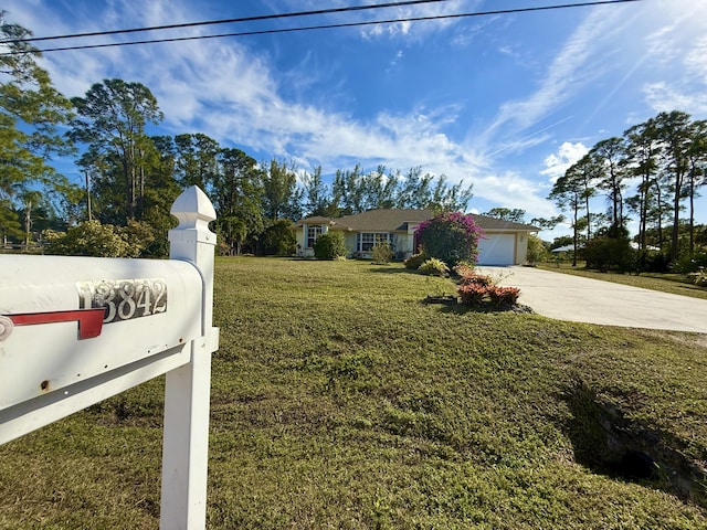 ranch-style house with a garage and a front yard