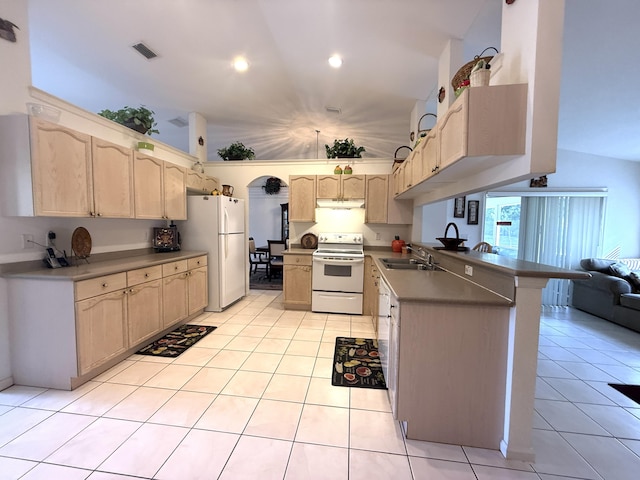 kitchen with sink, light tile patterned floors, light brown cabinets, kitchen peninsula, and white appliances