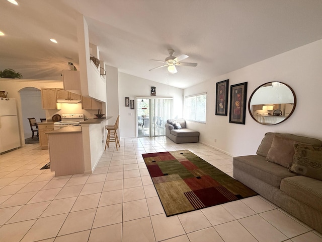 unfurnished living room featuring ceiling fan, vaulted ceiling, and light tile patterned floors