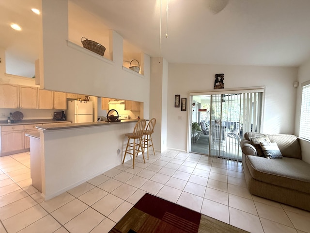 living room featuring a towering ceiling and light tile patterned floors