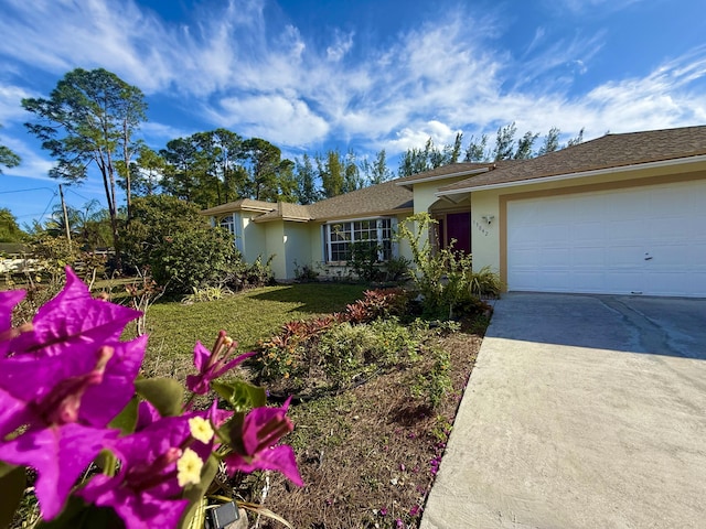 ranch-style home with a garage and a front yard