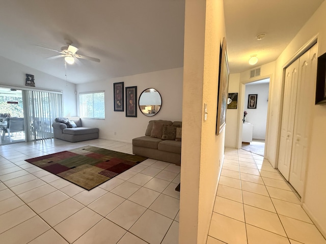 living room featuring light tile patterned floors and ceiling fan