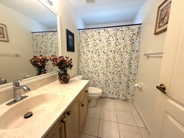 bathroom featuring vanity, tile patterned floors, and toilet