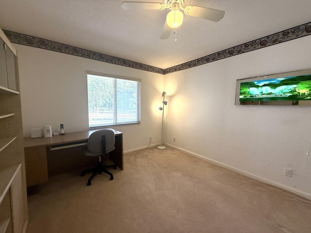 carpeted office space with ceiling fan