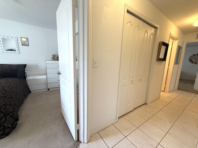 hallway featuring light colored carpet