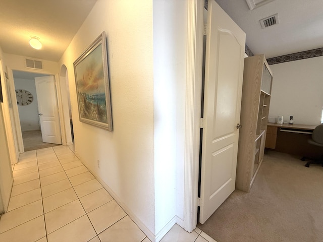 hall with light tile patterned floors