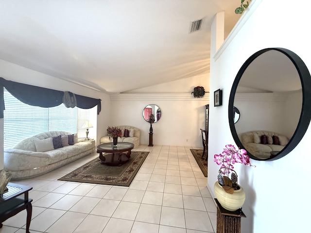 living room with light tile patterned floors and vaulted ceiling