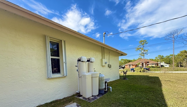 view of property exterior with a yard