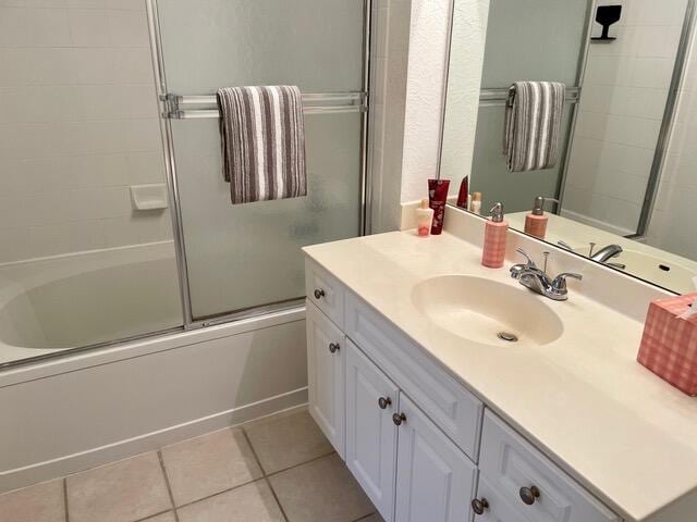 bathroom with vanity, bath / shower combo with glass door, and tile patterned floors