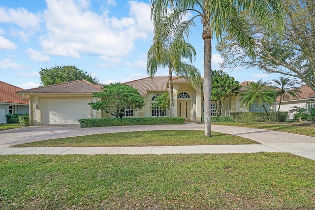 mediterranean / spanish-style house with a garage and a front yard