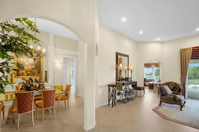 interior space featuring a towering ceiling and light tile patterned floors