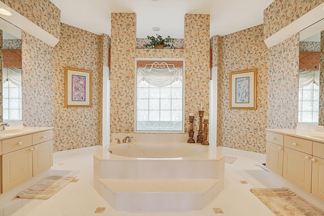 bathroom with tile patterned flooring, vanity, and a tub to relax in