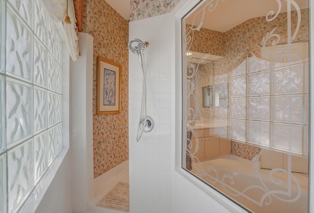 bathroom with tiled shower