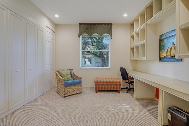 carpeted home office with built in desk