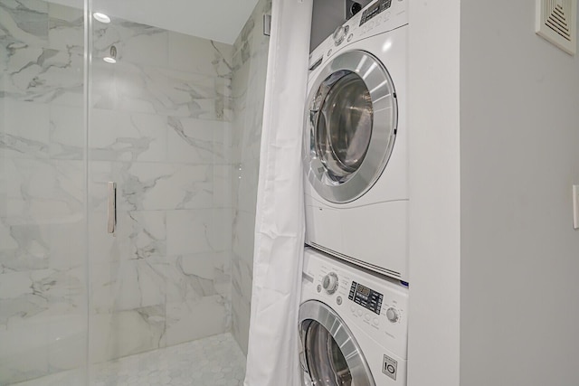 washroom with stacked washer / drying machine