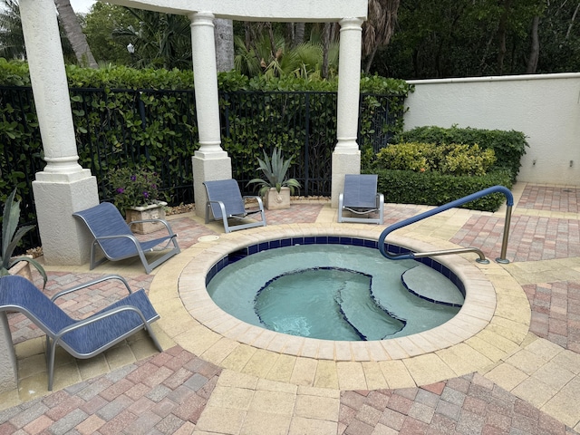 view of pool featuring an in ground hot tub and a patio