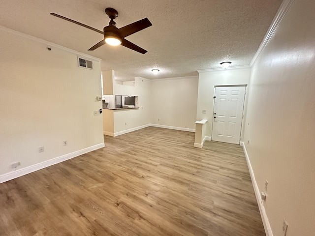 unfurnished living room featuring crown molding, ceiling fan, light hardwood / wood-style floors, and a textured ceiling