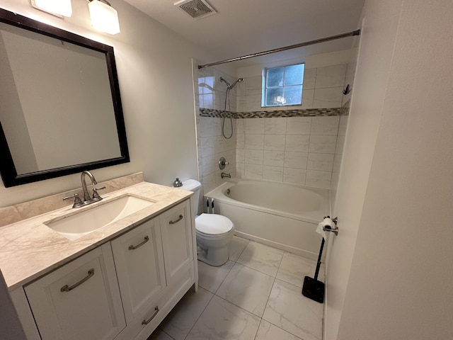 full bathroom with vanity, toilet, and tiled shower / bath combo