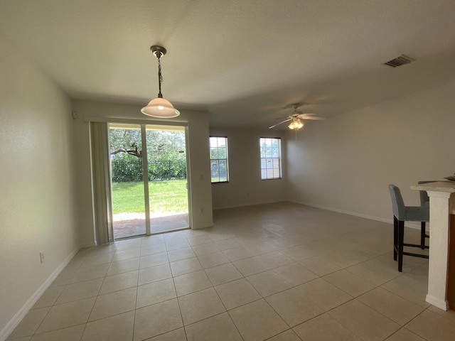 interior space with ceiling fan and light tile patterned floors