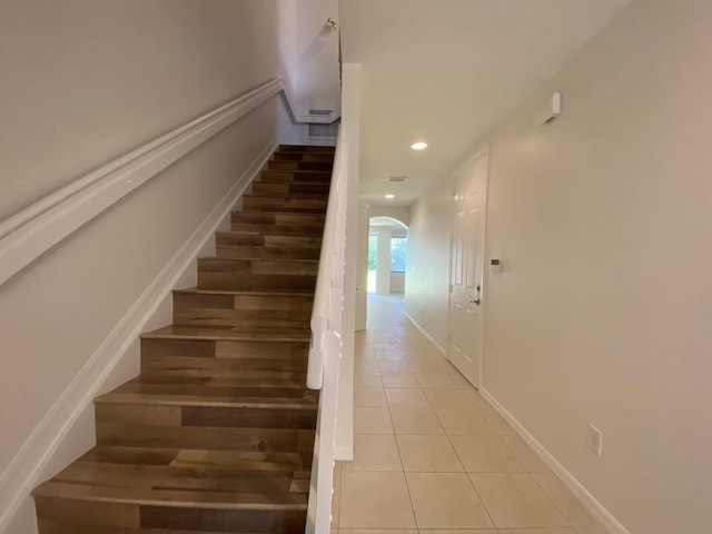 stairway with tile patterned flooring