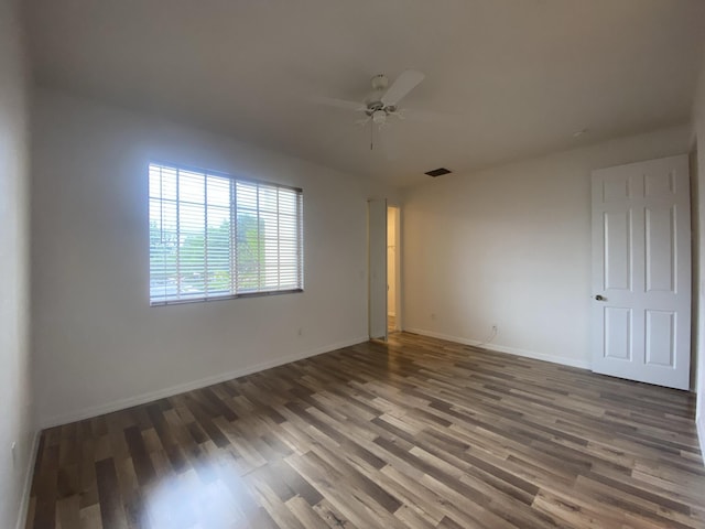 empty room with ceiling fan and wood-type flooring