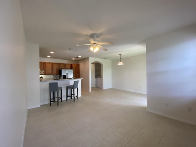 unfurnished living room featuring ceiling fan