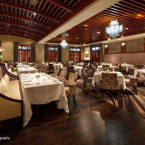 dining space with dark hardwood / wood-style floors and a notable chandelier