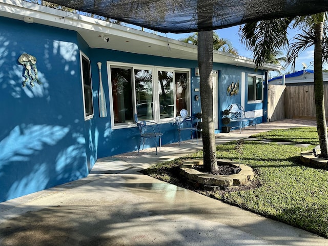 exterior space featuring a lawn and a patio