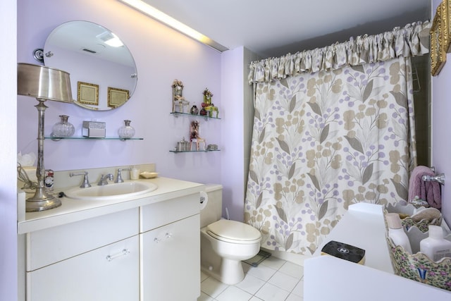 bathroom with tile patterned floors, vanity, and toilet