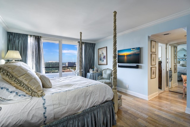 bedroom featuring ornamental molding and light hardwood / wood-style floors