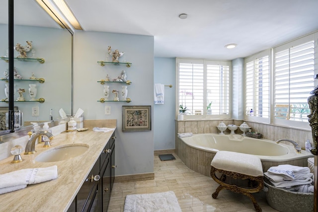 bathroom featuring vanity and tiled bath